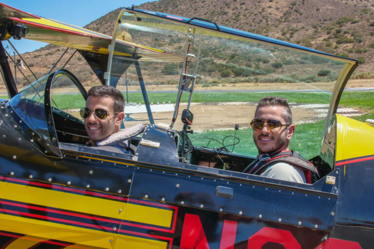 Moe Tarakji and Sam Tarakji seated in the Pitts biplane cockpit at Van Nuys, preparing for an aerobatic flight.