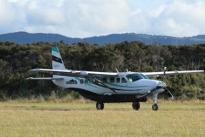 Cessna Grand Caravan on a grass runway, used as an advanced training aircraft for Commercial Pilot License students.