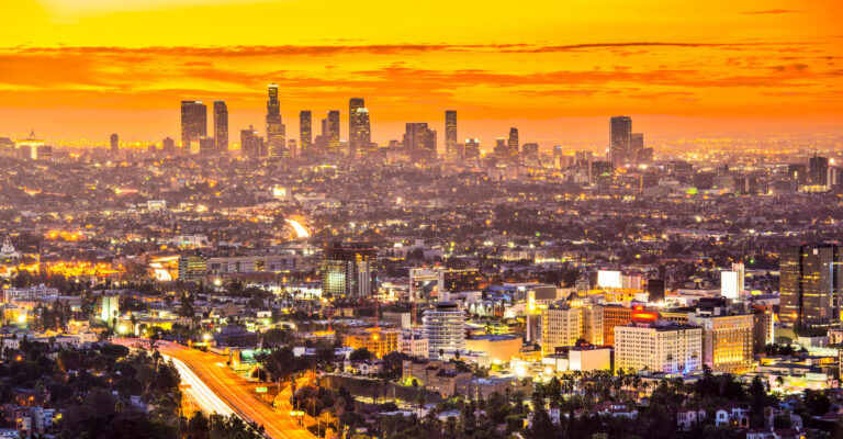 LA downtown on the horizon during sunset, seen from the air during a sunset discovery flight