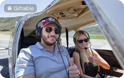 Couple enjoying a discovery flight from a small aircraft
